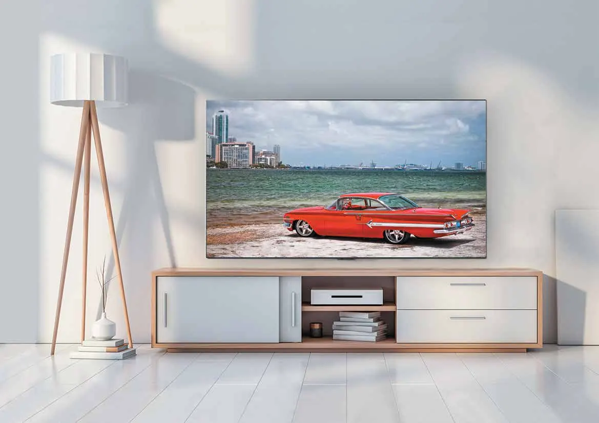 OXY TV on a wooden console in a bright room